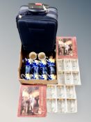 Two boxed Pieroth Jubilee Glass Collection sets and a box of luggage case, mugs,