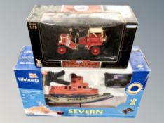 A remote controlled life boat together with a die cast gold plated Ford Model T fire engine.