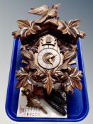 A Black Forest style cuckoo clock with pendulum and weights