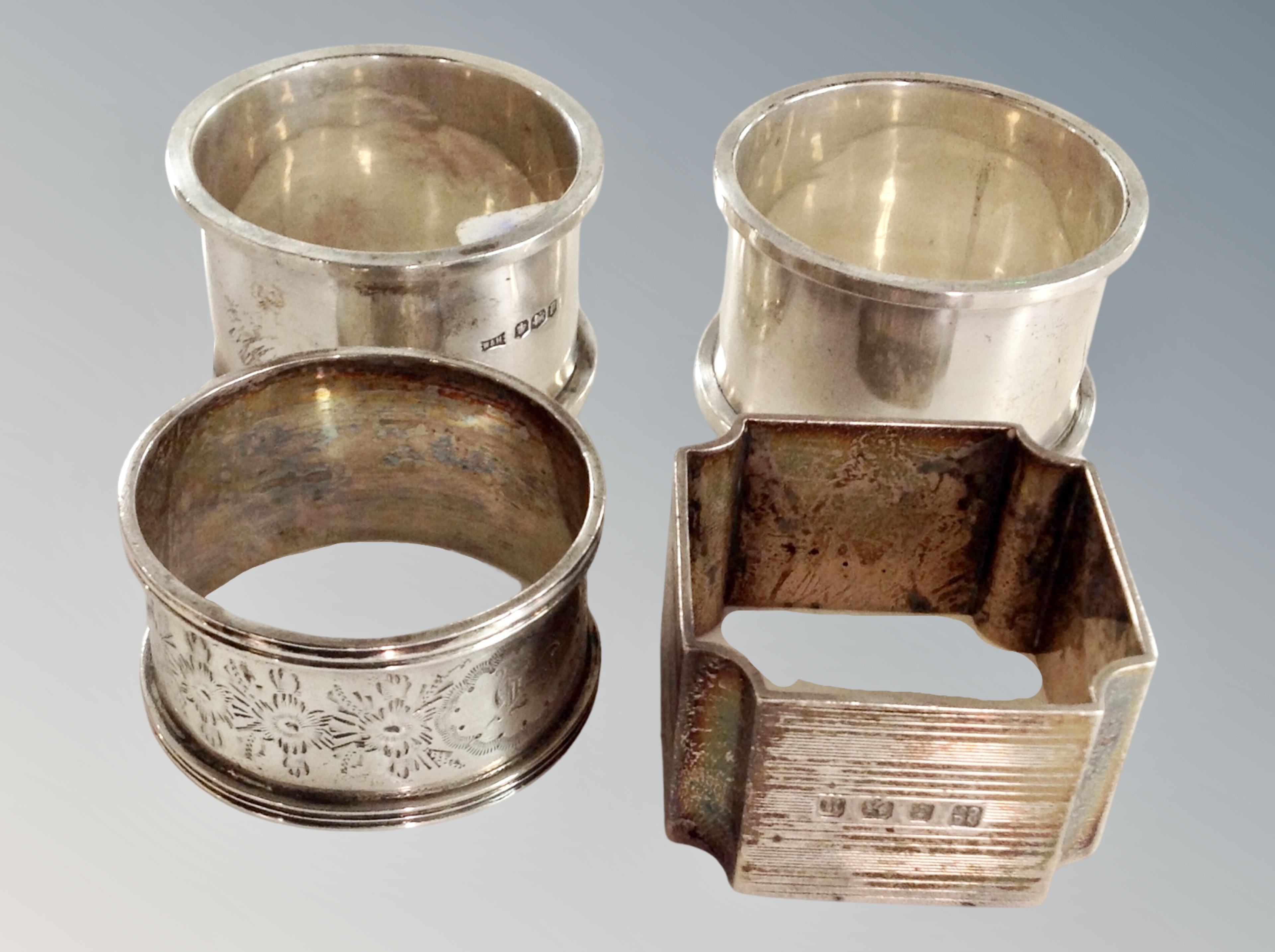 Four silver napkin rings.