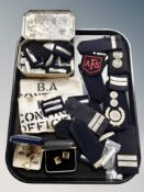 A tray of police and fire service epaulettes,