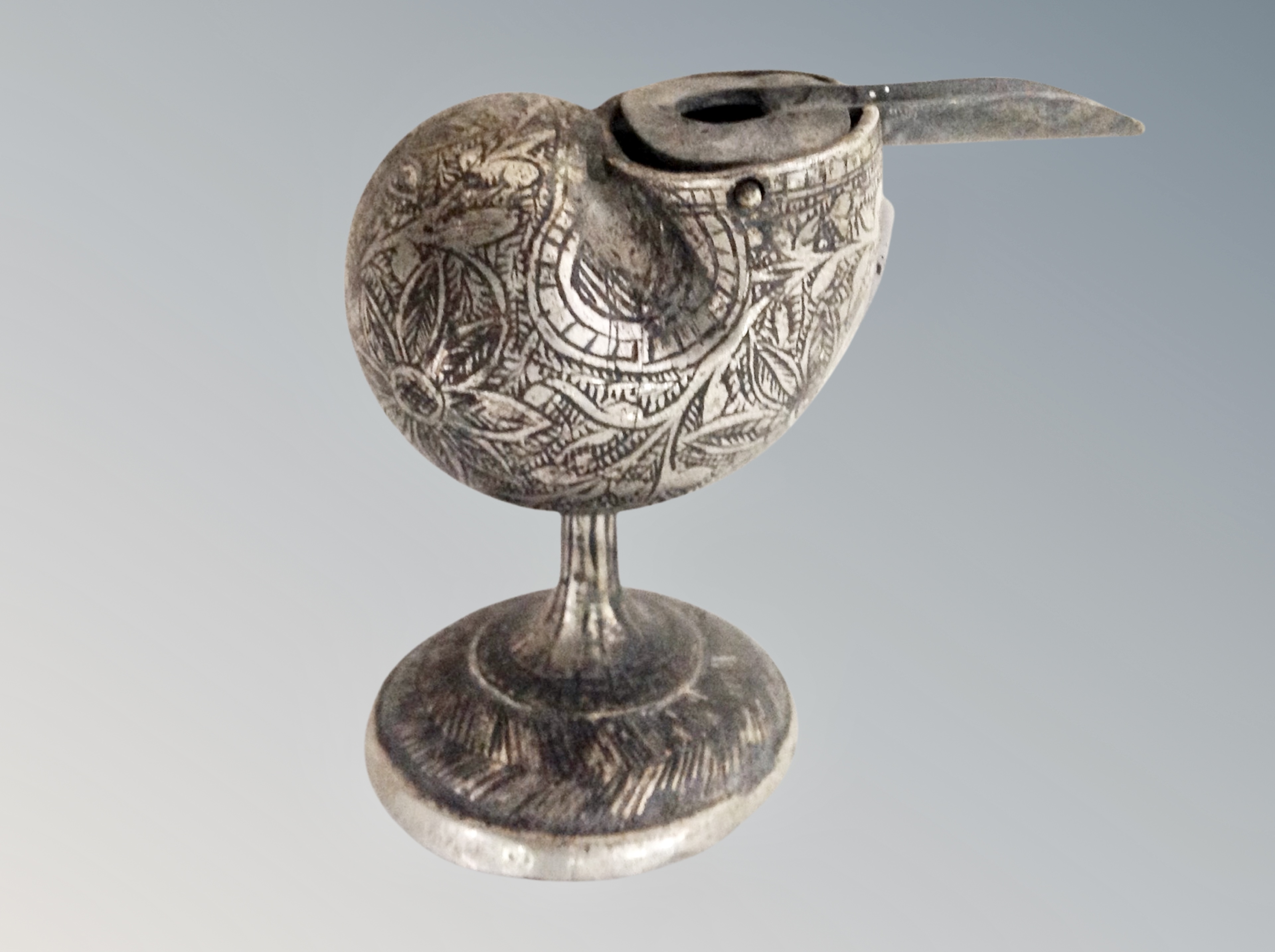A silver plated and engraved inkwell in the form of a shell,