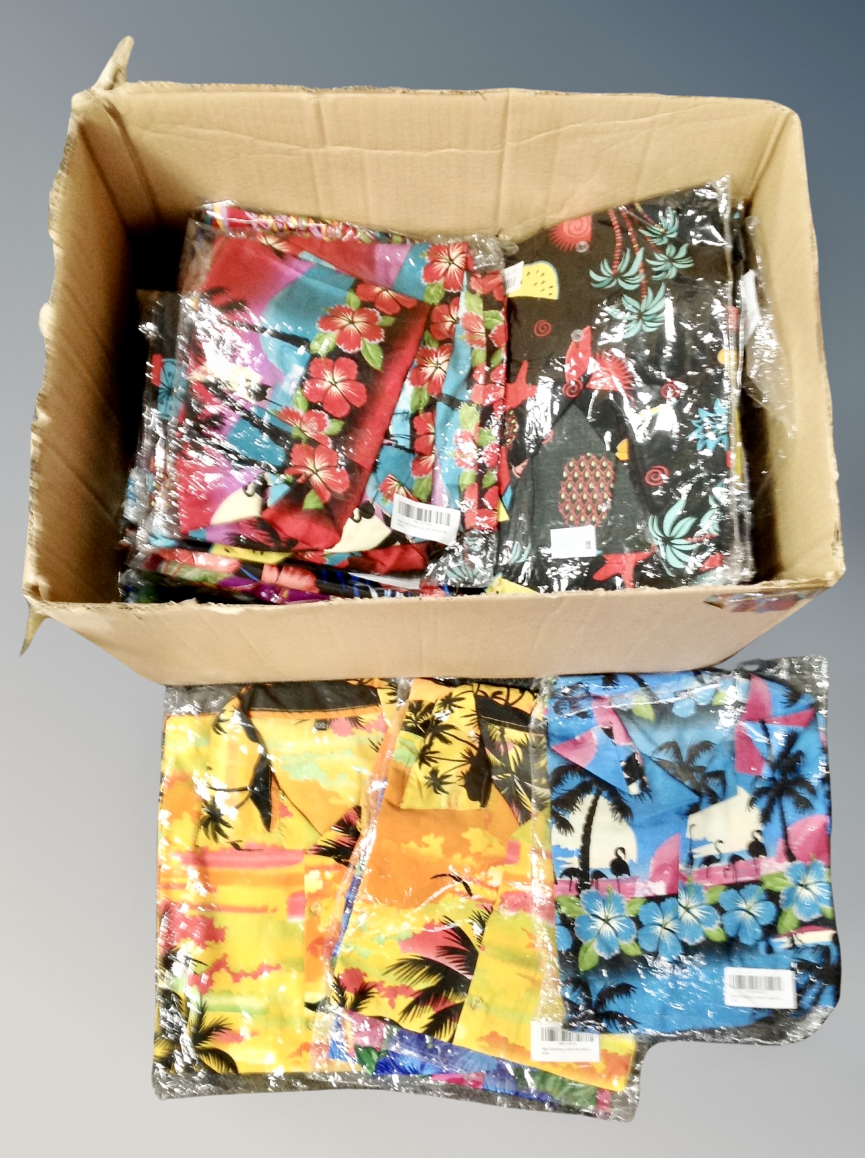A box of approximately 68 men's Hawaiian shirts.
