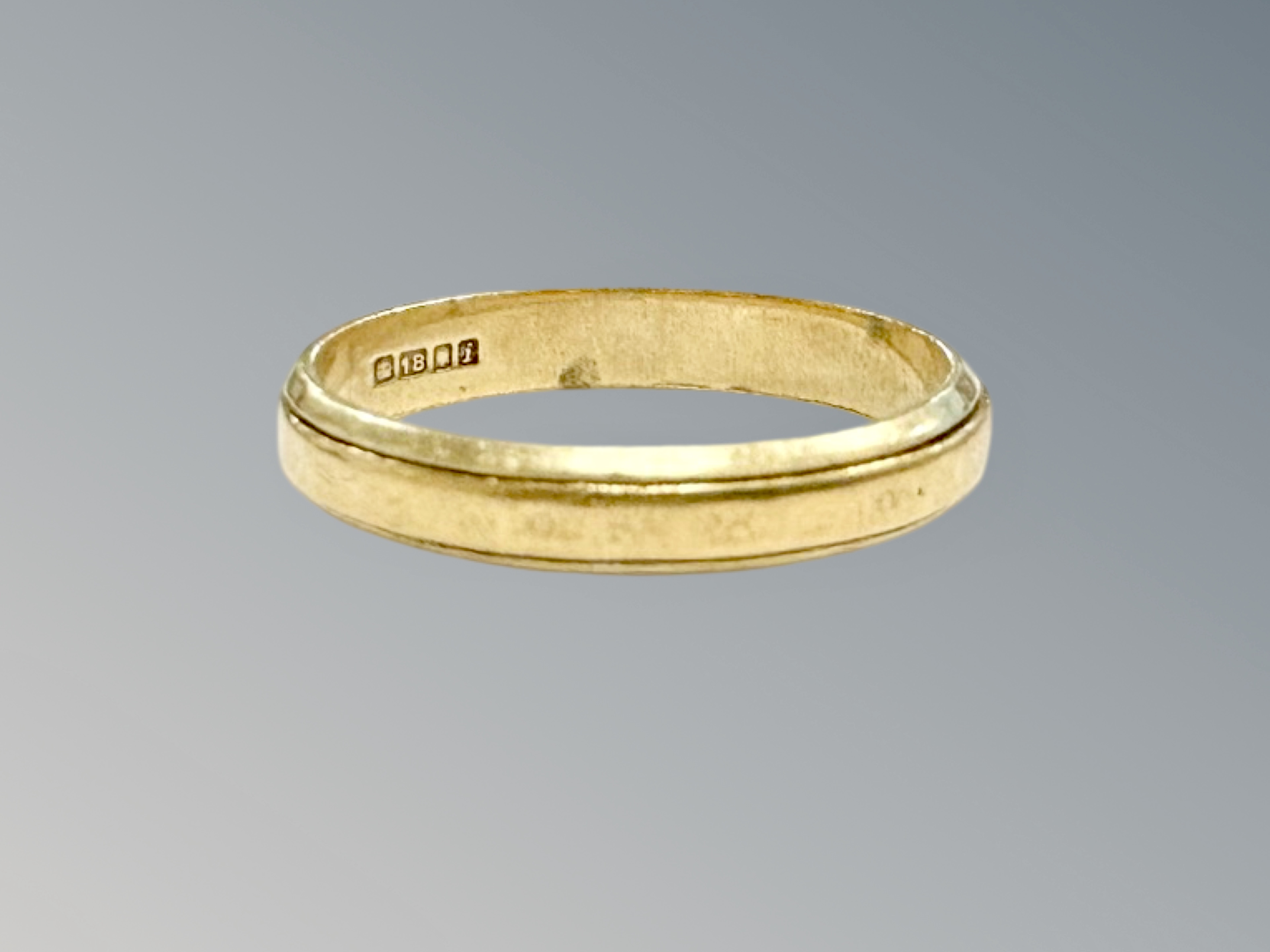 An 18ct gold band ring, size N CONDITION REPORT: 2.