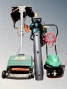 An electric leaf blower together with a garden lawn raker and rotivator