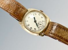 A gent's 9ct gold cushion-shaped wristwatch, case 32mm.