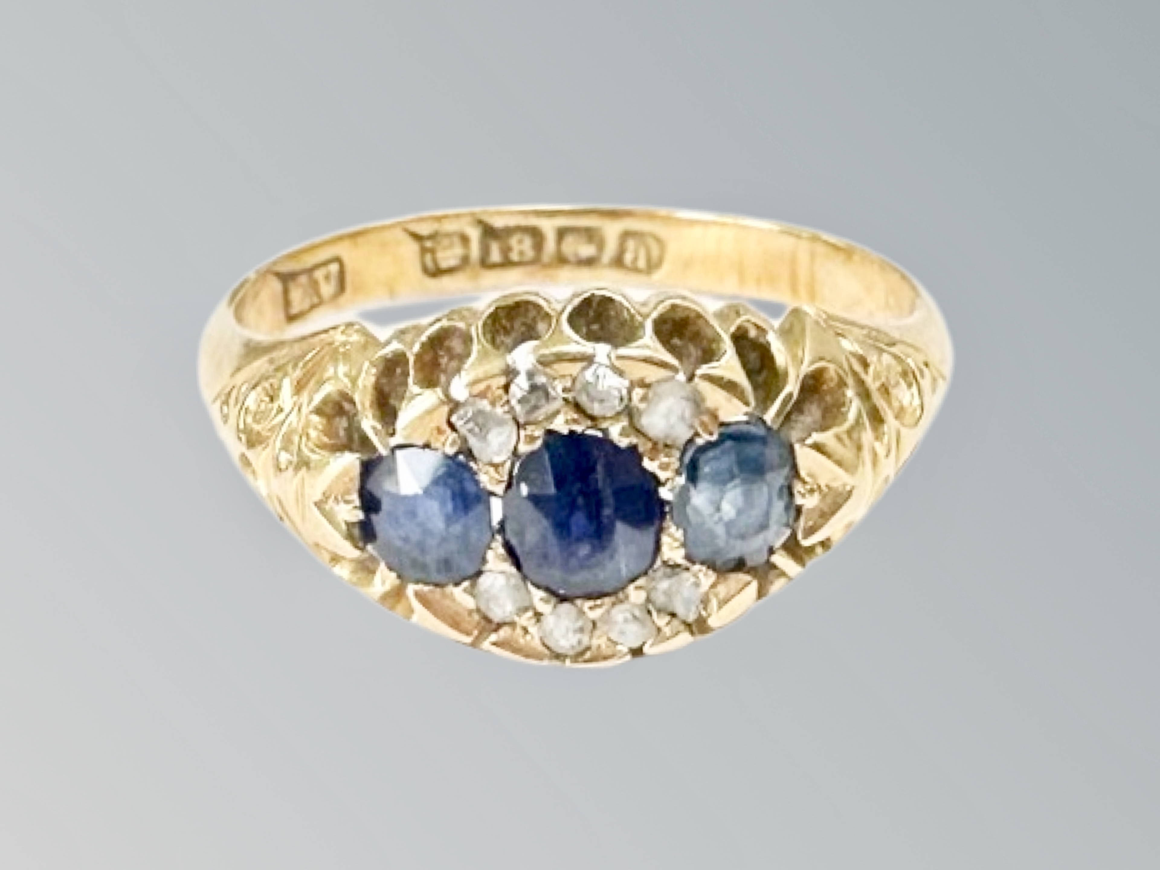 An 18ct gold sapphire and diamond ring, size L CONDITION REPORT: 3.