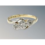 An 18ct gold and platinum three stone diamond ring, size K. CONDITION REPORT: 2.