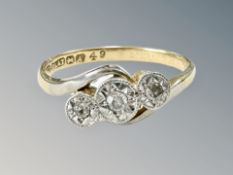 An 18ct gold and platinum three stone diamond ring, size K. CONDITION REPORT: 2.