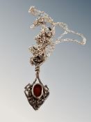 A silver pendant and chain