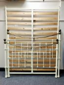 An antique style cream metal 4'6" bed frame