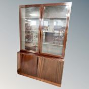 A continental mahogany glazed bookcase fitted with cupboards,