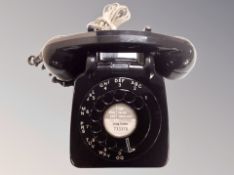 A vintage style black plastic telephone