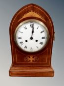 An Edwardian inlaid mahogany arched-topped eight day mantel clock,