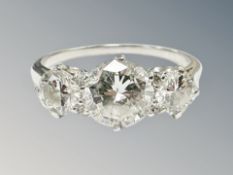 A platinum three stone diamond ring, the principal stone weighing 1.