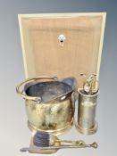 A brass coal bucket with accessories and spark guard