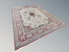 A carpet of Iranian Tabriz design, 403 cm x 293 cm CONDITION REPORT: Wear to pile.