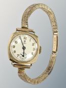 A lady's 9ct gold Tudor wristwatch upon a 9ct gold Rolex articulated strap,
