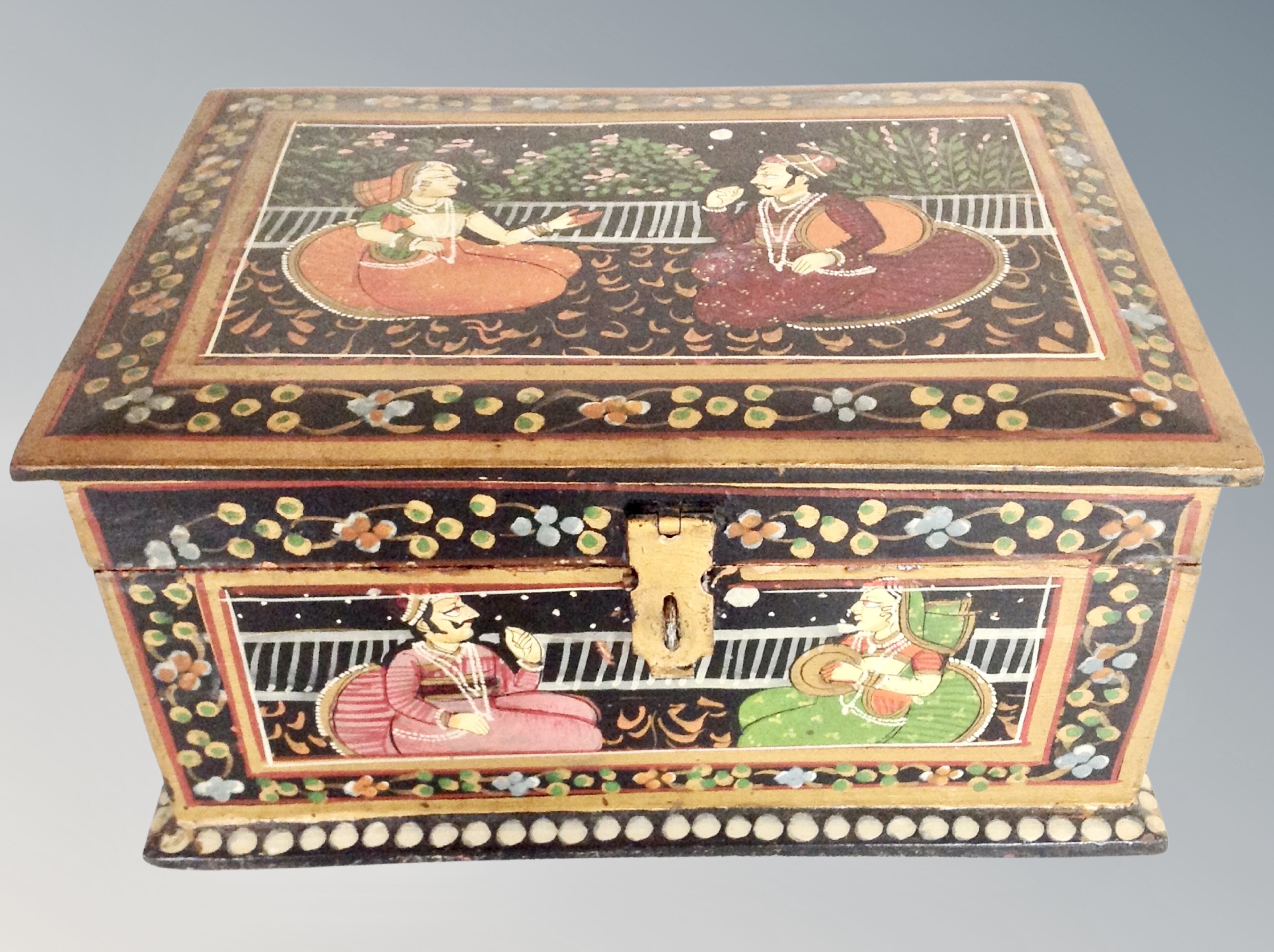 An Indian hand painted table box decorated with figures,
