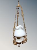 A continental gilt metal and opaque glass hanging oil lamp,