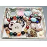 A small tray of polished stone polar bear, jade ring, polished stone pendant, earrings,