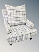 A contemporary armchair in checked fabric with cushion