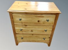 A pine three drawer chest,