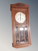 A early 20th century eight day wall clock in oak case