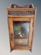 A Victorian walnut smoker's cabinet with glazed door,