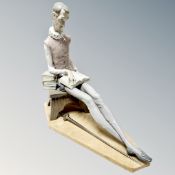 A Nao figure of a seated Don Quixote with sword on plinth