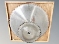 Two large industrial saw blades, the largest diameter 65 cm.