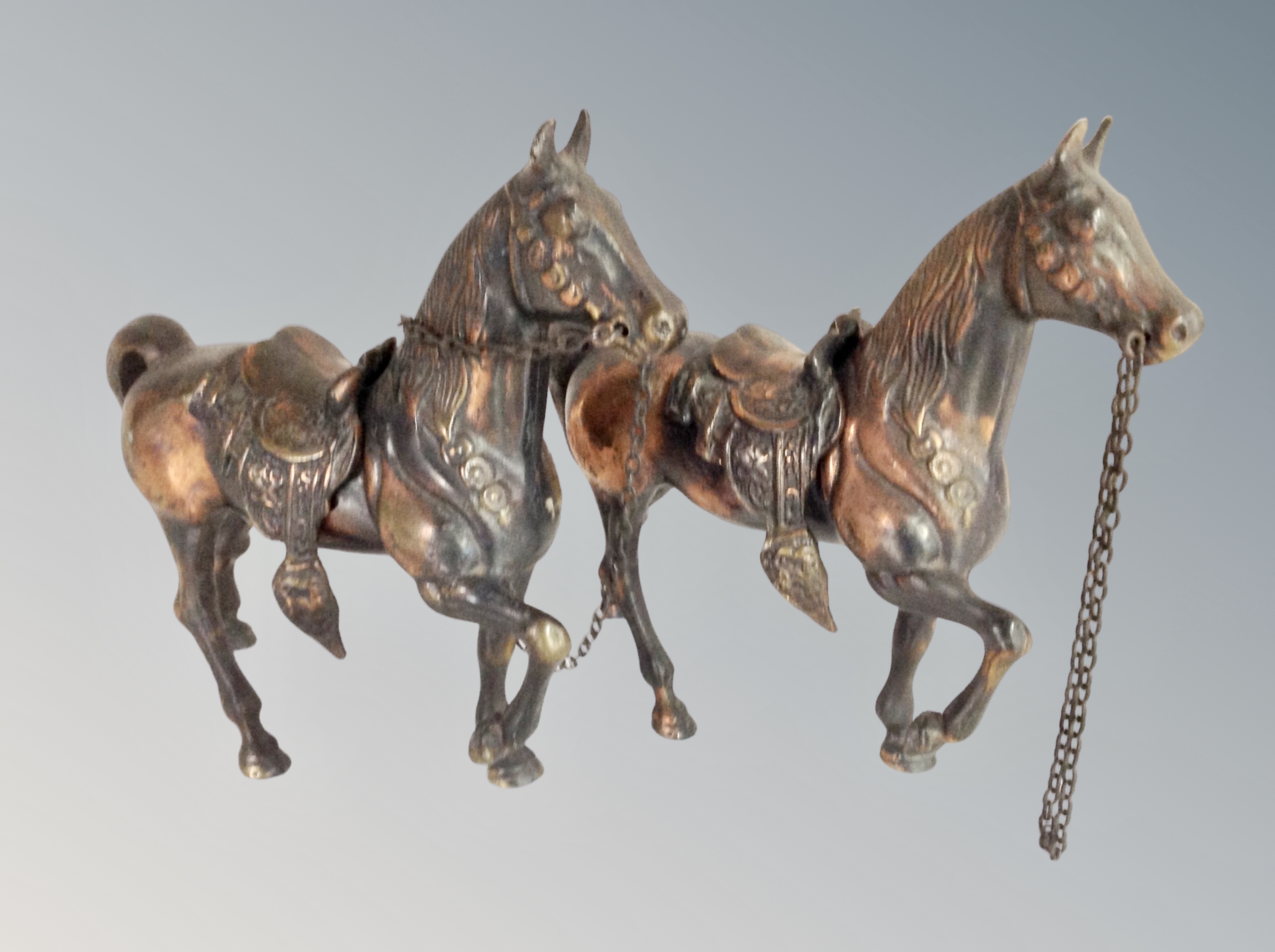 Two patinated metal figures of horses,