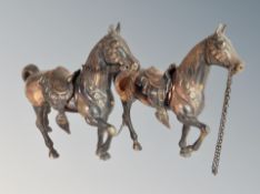 Two patinated metal figures of horses,