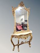An ornate reproduction gilded two-piece console table with mirror, table width 130 cm,