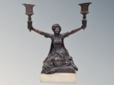 A bronze figural two-branch candelabrum on plinth,