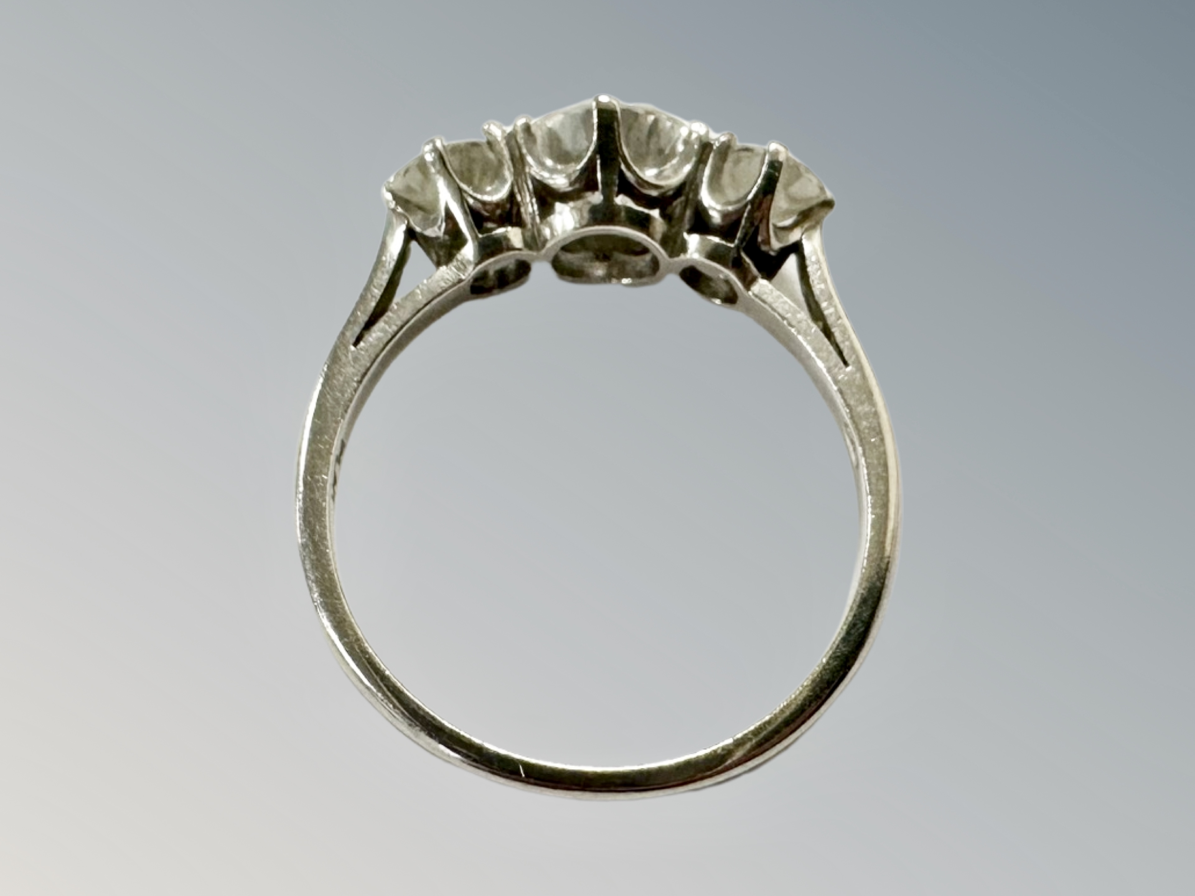 A platinum three stone diamond ring, the principal stone weighing 1. - Image 3 of 3