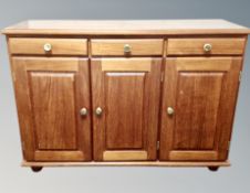 A contemporary stained pine sideboard,