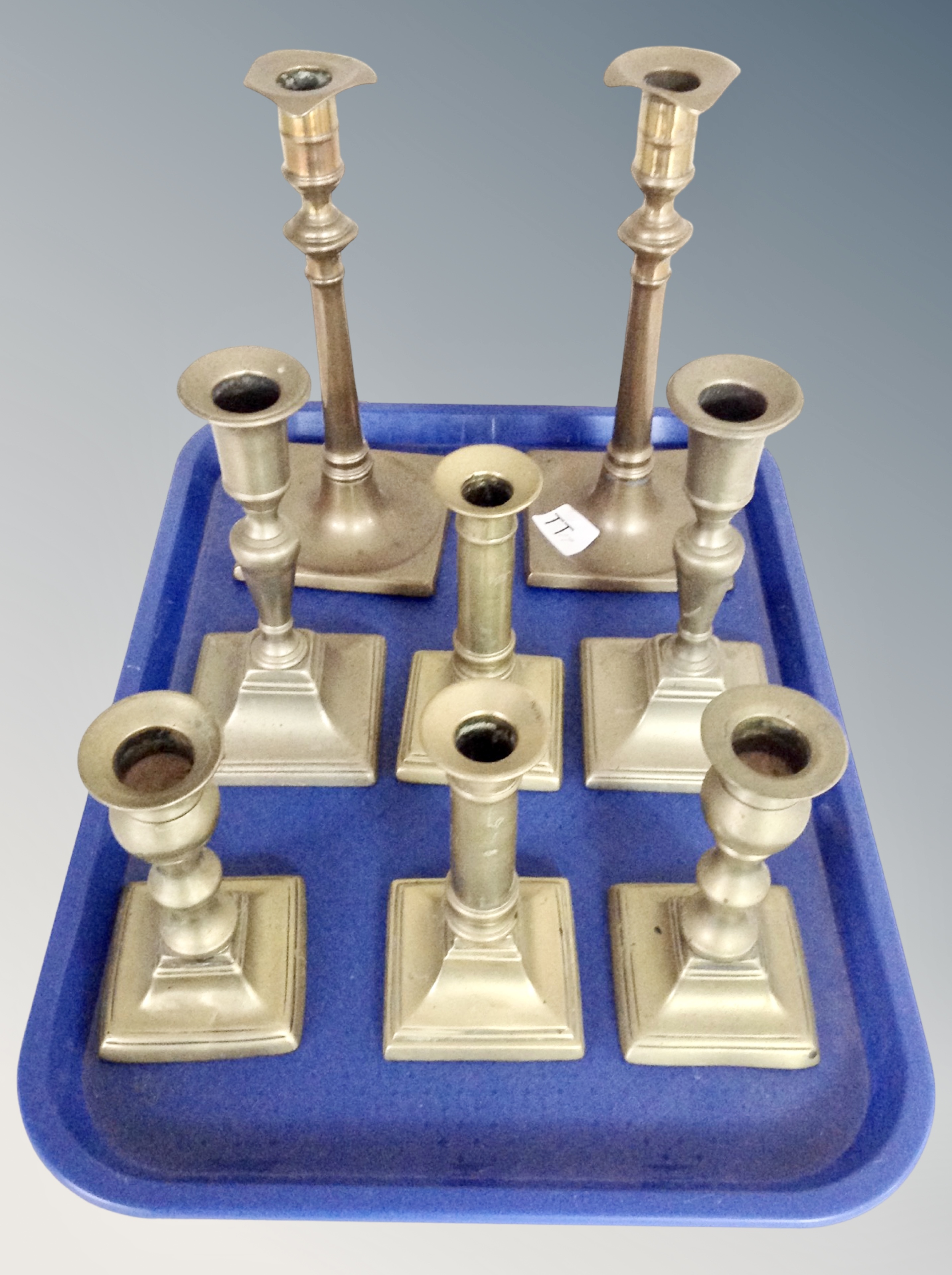 Four pairs of brass candlesticks,