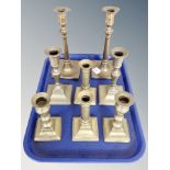 Four pairs of brass candlesticks,