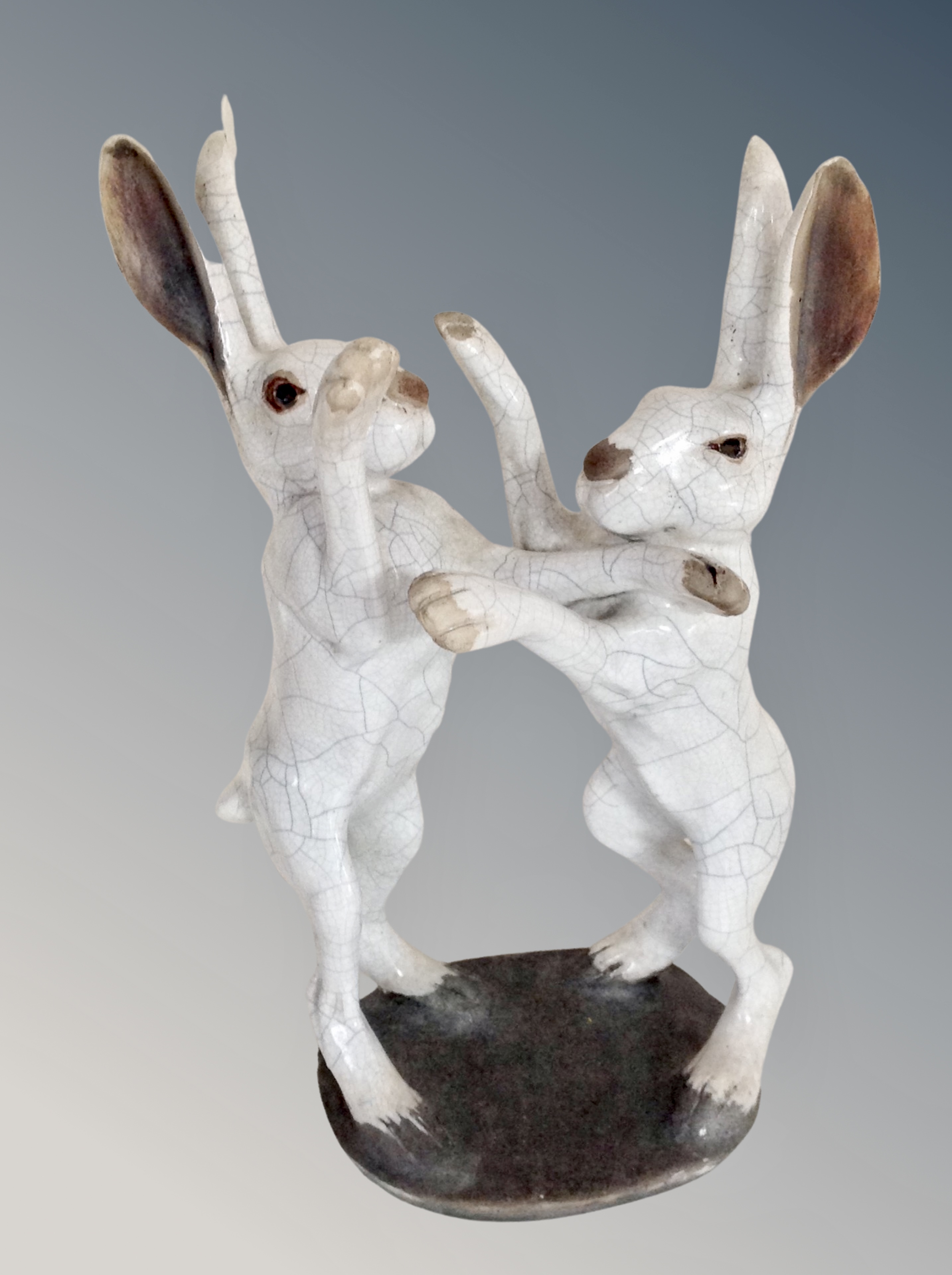 Brian Andrew : A raku fired figure group of two fighting hares, signature under base,