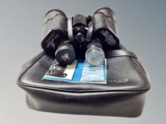 A pair of Tasco 20 x 50 mm binoculars in leather case