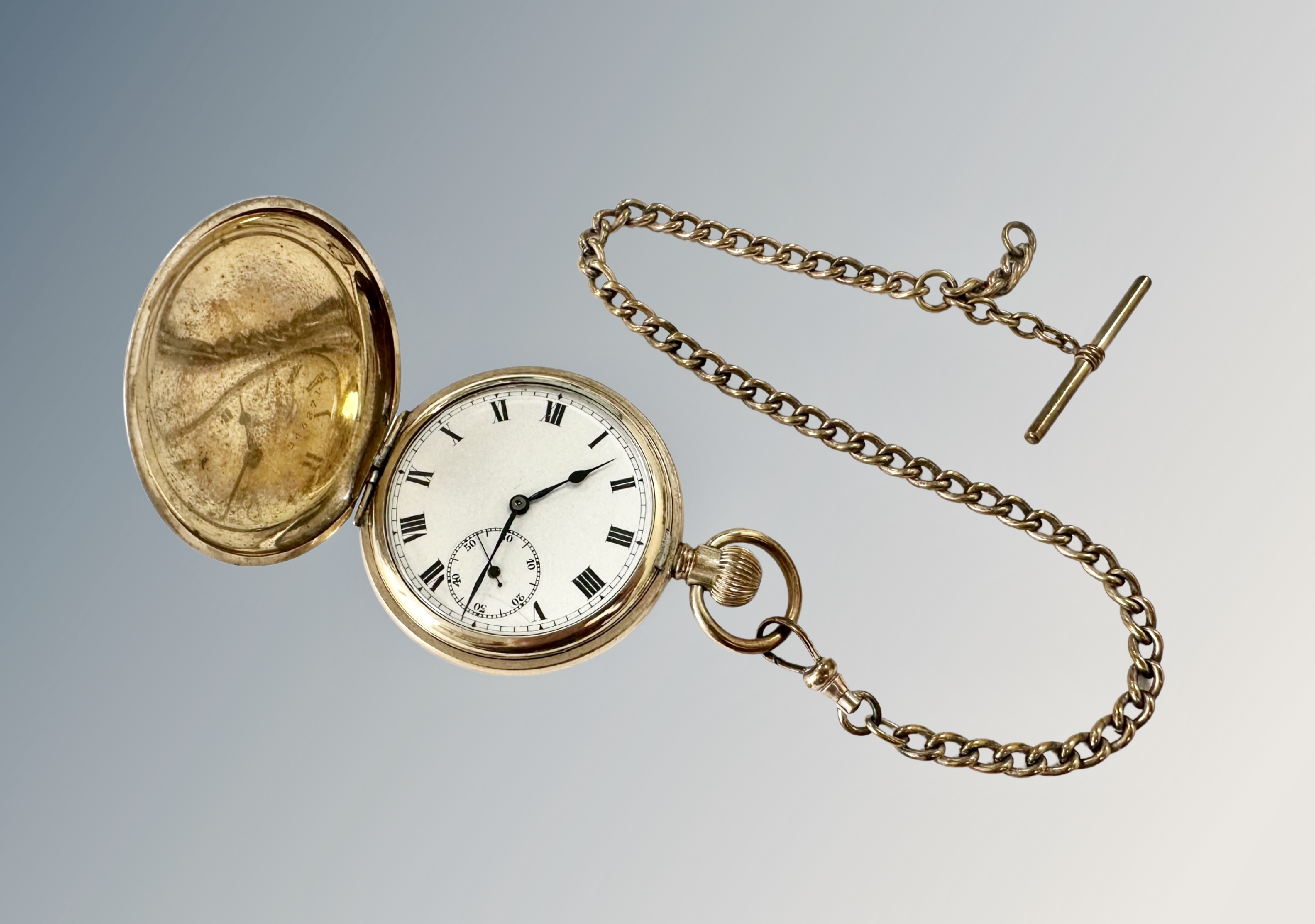 A gold plated open face pocket watch on gilt Albert chain