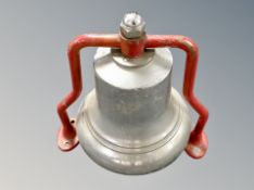 A vintage fire bell on bracket.
