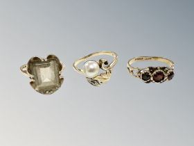 A 9ct gold garnet ring, similar quartz ring and a 14ct gold pearl ring.