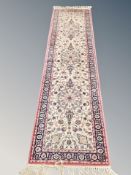 A machine made runner of Persian design,