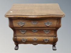 An oak bombe chest of drawers