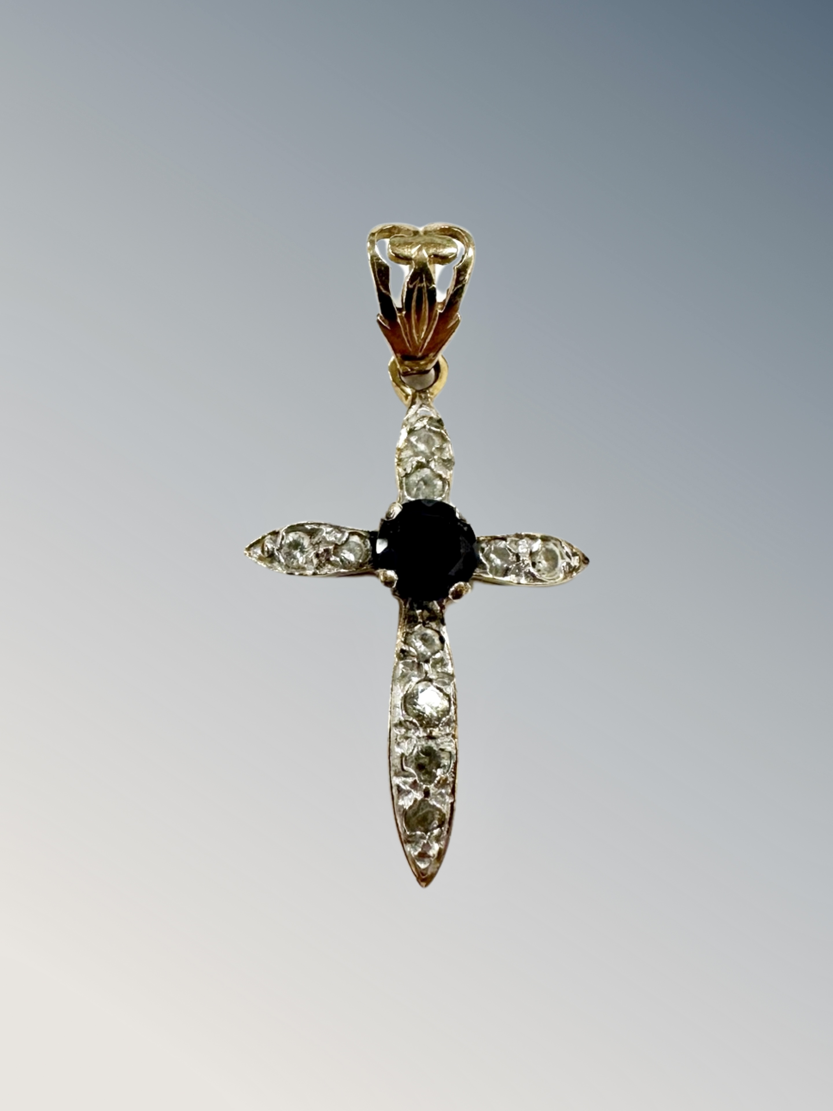 A 9ct yellow gold crucifix set with synthetic sapphire 1.9g., length 3 cm including bale.