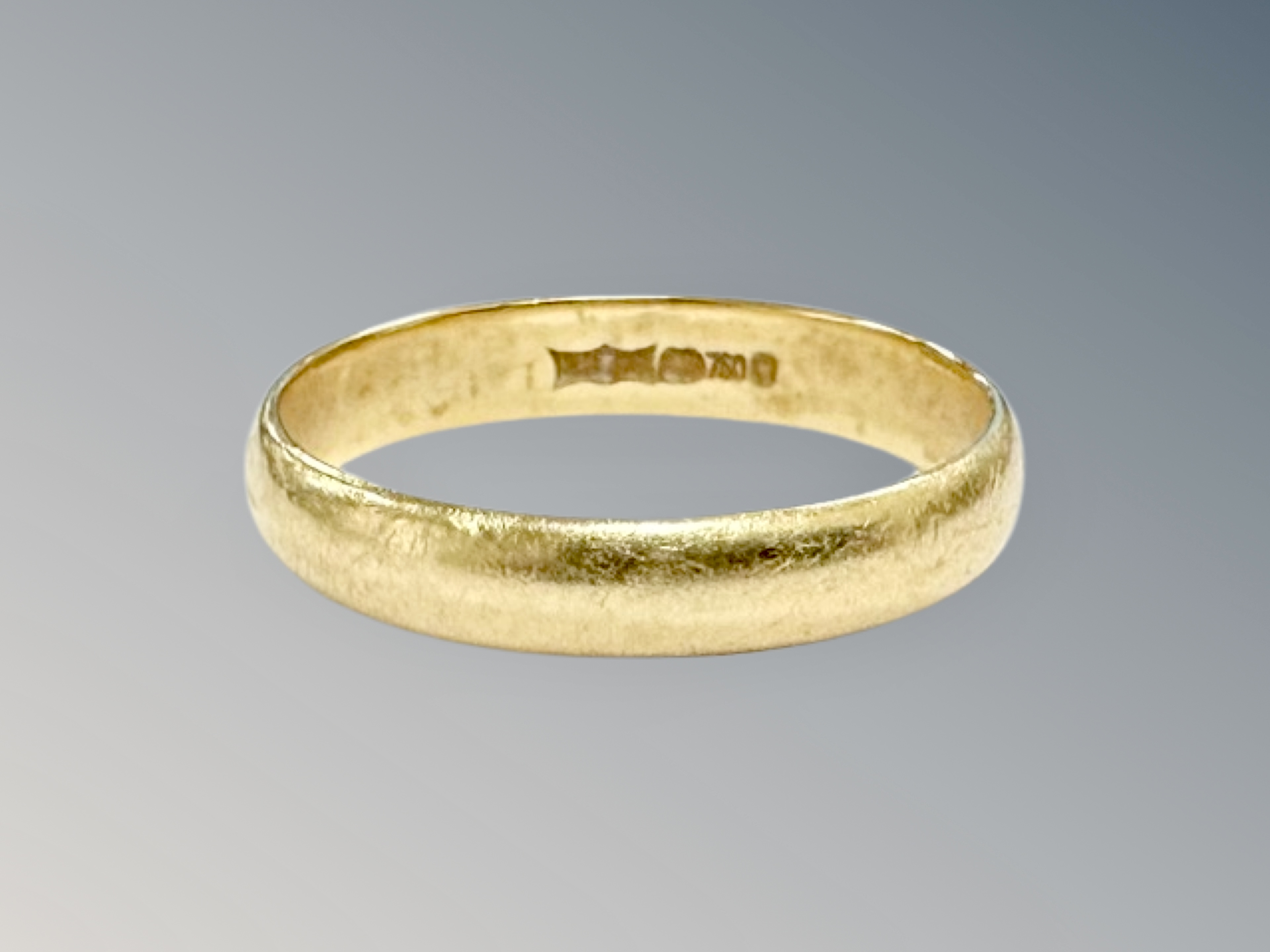 An 18ct gold band ring, size L CONDITION REPORT: 2.