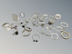 Thirty dress rings, mostly silver or gold on silver.