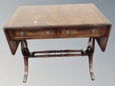 A Regency style mahogany flap sided sofa table fitted with two drawers